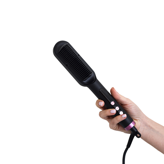 Hand holding the PH Ring Pro hair straightening brush showing the bristle head and pink control buttons